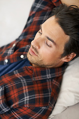 Image showing Relax, sleeping and man on sofa in home for afternoon nap, resting and calm in living room. Asleep, eyes closed and face closeup of tired person on couch lying for fatigue, comfortable and wellness