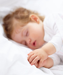 Image showing Hands, baby and kid sleeping on bed for calm break, peace and dreaming to relax at home. Tired, young child and cozy nap for newborn development, healthy childhood growth and rest in nursery room