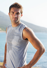 Image showing Sports, portrait and man athlete running with sweat on road for exercise, cardio or outdoor training. Active, fitness and young male person with smile and earphones for music, playlist or album.