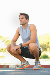 Image showing Sports, break and man athlete in nature with earphones training for race, marathon or competition. Fitness, exercise and young male runner listening to podcast, radio or playlist for cardio workout.