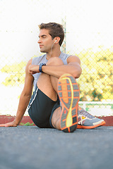 Image showing Fitness, break and man athlete in nature with earphones training for race, marathon or competition. Sports, exercise and young male runner listening to podcast, radio or playlist for cardio workout.