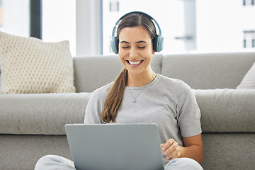 Image showing Happy, headphones and laptop with woman online in home with remote work, music and living room with smile. Podcast, tech and internet with radio streaming and audio with computer by a sofa with job