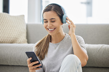Image showing Happy, headphones and phone with woman at home with remote work, music and living room with smile. Podcast, tech and internet with radio streaming and audio with mobile by a sofa with digital job