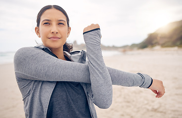 Image showing Beach, fitness and woman stretching arms in nature for running, training or morning cardio. Exercise, warm up or face of runner at sea for sports, wellness or health, workout or Cape Town ocean run