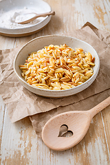 Image showing Cooked italian pasta, risoni, orzo in a bowl on wooden table