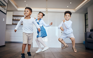 Image showing Family, children and siblings dance in a house with energy, moving and music at home together. Love, freedom and kids in living room for fun jump games, bond and celebration of vacation or weekend