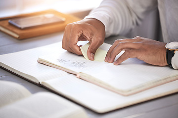 Image showing Hands, closeup and sticky note with book on desk for reading, studying and knowledge with planning for analysis. Person, reminder and notebook on table for schedule, project management and process