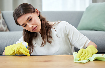 Image showing Woman, cloth and gloves for cleaning wood table for spray, chemical or hygiene in home living room. Girl, cleaner and services with liquid, fabric or product for dust, shine or stop bacteria in house