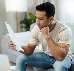 Image showing Serious man, documents and thinking for debt or planning in decision on living room sofa at home. Male person with paperwork in thought or choice for financial plan, expenses or bills at house