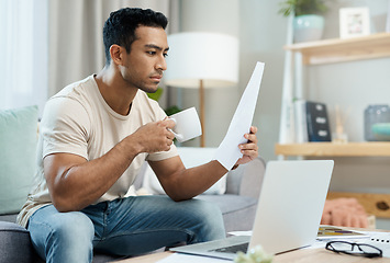 Image showing Asian man, laptop and documents with coffee in finance, expenses or checking bills on living room sofa at home. Male person with paperwork, latte or cup of tea reading contract or insurance at house