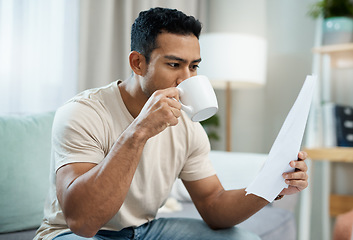 Image showing Asian man, documents and drinking coffee in finance, expenses or checking bills on living room sofa at home. Male person with paperwork, latte or cup of tea and reading contract or insurance at house