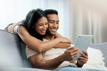 Image showing Happy, love and couple hug with tablet on sofa for social media, movies or streaming film at home. Support, smile or people in living room with digital, search or app for show, video or communication
