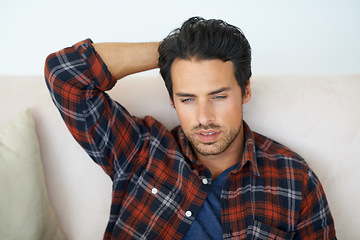 Image showing Thinking, mistake or regret with a man on a sofa in the living room of this home for problem solving. Stress, idea or depression and a young person in his apartment feeling shame, guilt or remorse