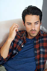 Image showing Man, thinking and serious on sofa for question, idea and contemplating in living room of apartment or home. Person, face and mental health or thoughtful on couch in lounge for anxiety on weekend