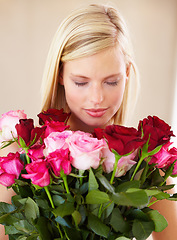 Image showing Woman, rose bouquet and eyes closed with face, beauty and arrangement with studio background, happy or gift. Smell, female model or flowers for love, present and valentines day with romantic gesture