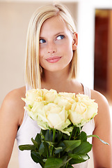 Image showing Woman, rose bouquet and eyes with face, holding and floral arrangement in house, confident and gift. Look, female model and flowers for love, present and valentines day with romantic gesture