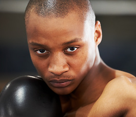 Image showing Boxing, gloves and portrait of fearless black man training with fitness, power and workout challenge. Strong body, muscle and boxer in gym, athlete with fist up and confidence in competition fighting