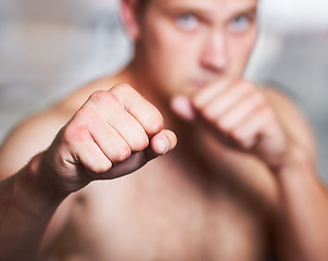 Image showing Boxing, hands and portrait of man on blurred background with fitness, power and training challenge. Strong body, muscle and boxer in gym, athlete with fist up and confidence for competition fight.