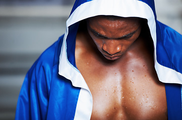 Image showing Black man, robe and boxing champion getting ready for fight, challenge or sports competition at gym or ring. Serious African male person, fighter or boxer in preparation for MMA match or game start