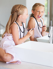 Image showing Kid, lipstick and smile for mirror in bathroom with mark, writing or drawing with bad behavior. Little girl, happy and laugh for picture, naughty and problem with mom, makeup or cosmetics for beauty