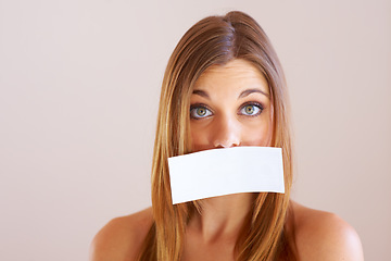 Image showing Woman, mouth and sign for cover with mock up for silence in studio on white background. Portrait, female model and surprise in copy space for announcement, news or secret with placard, sign or poster