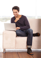 Image showing Man, typing and work from home on laptop for graphic design career, planning and research on website and sofa. Startup freelancer or online designer relax on couch with computer and happy project