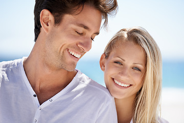 Image showing Love, smile and portrait of couple on beach for date, outdoor bonding and tropical holiday. Romance, man and woman at sea, hugging and relax on ocean vacation together with travel, care and adventure