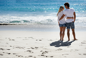 Image showing Hug, beach and back of couple in nature with freedom, romance or care, trust or support. Love, embrace and people at the sea for travel, fun and summer, vacation or adventure while bonding in Florida