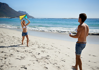 Image showing Couple, kite playing and fun by beach in summer with love, care and support together on a holiday. Happy, vacation and date by the sea in Miami with freedom and travel by the ocean on a trip outdoor