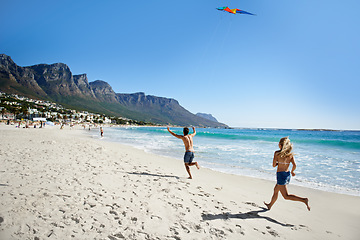 Image showing Couple, running and summer with kite, beach and summer sunshine for vacation, freedom or play in air. Man, woman and speed to launch wind toys, bonding or holiday by sea on adventure in Naples, Italy