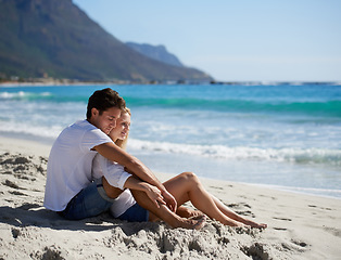 Image showing Love, embrace and couple on beach for date, outdoor bonding and tropical holiday. Romance, happy man and woman at sea, hugging and relax on ocean vacation together with travel, care and adventure.