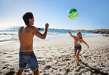 Image showing Couple, ball playing and fun by beach in summer with love, care and support together on a holiday. Happy, vacation and date by the sea in Miami with freedom and travel by the ocean on a trip outdoor