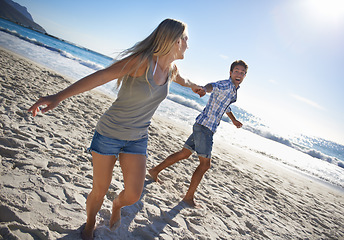 Image showing Couple, playing and fun by beach in summer with love, care and support together on a holiday. Happy, vacation and date by the sea in Miami with freedom and travel by the ocean on a trip outdoor