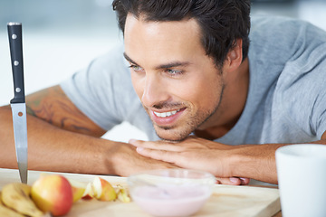 Image showing Man, fruit and kitchen in morning breakfast diet or health nutrition, eating vitality or banana for protein. Male person, yogurt and apple detox meal for hungry vegan preparation, fiber or vitamins
