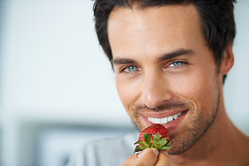 Image showing Home portrait, happy man and eating strawberry for morning diet, healthy lifestyle or fruit benefits, wellness or breakfast. Natural detox, nutrition food and face of person smile for antioxidants