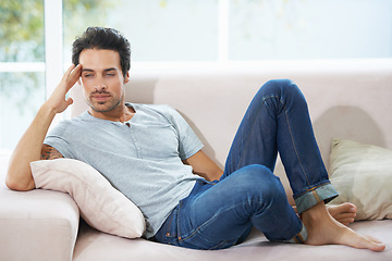 Image showing Thinking, depression and man on a sofa with stress, anxiety or broken heart in his home. Sad, crisis or male person in living room overthinking, disaster or lonely, worried or disappointed in a house