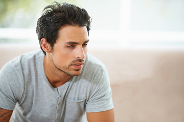 Image showing Sad man, thinking and depression on a sofa with stress, anxiety or broken heart at home. Fail, crisis or male person in living room overthinking, disaster or lonely, worried or disappointed in house