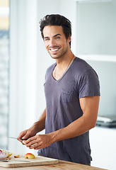 Image showing Man, portrait and fruit cutting as morning breakfast or diet nutrition, wellness health or vitamin fiber. Male person, apple preparation and vegan meal as weight loss detox, yogurt on kitchen counter