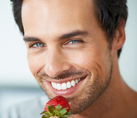 Image showing Portrait, happy man and eating strawberry, healthy food or fresh product for weight loss, vegan diet or organic snack. Happiness, face headshot and closeup nutritionist smile for fruit nutrition meal