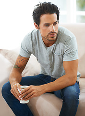 Image showing Coffee cup, thinking and home man relax, planning or brainstorming ideas, decision or choice on living room sofa. Tea mug, pensive morning and person thoughtful over plan, problem solving or solution