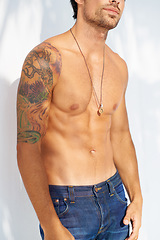 Image showing Fashion, tattoo and body with a man outdoor on a white background for edgy or unique style. Health, fitness and denim jeans with a shirtless model in the sunlight for masculine or macho style