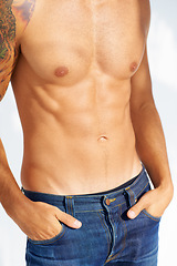 Image showing Relax, body and jeans with a man in studio isolated on a white background closeup for masculine style. Fashion, muscle or macho and a cool, shirtless person in denim with his hands in his pockets