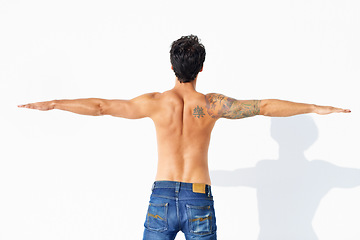 Image showing Back, muscle and shirtless with man, stretching and promotion isolated on a white studio background. Person, guy and model with exercise, jeans or fitness with health, mockup space and body with care