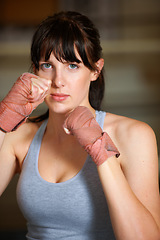 Image showing Boxing, hands and portrait of woman with fitness, power and fearless training challenge in gym. Strong body, muscle and face of boxer, athlete or girl with fist up for confidence in competition fight