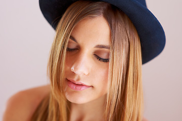 Image showing Woman, eyes closed and hat for fashion in studio with mock up for style on white background. Swedish model, hairstyle and confidence by satisfaction on face with vintage, clothes and fedora in space
