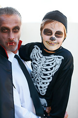 Image showing Portrait, halloween and costume with a father and his son outdoor for a trick or treat tradition together. Family, horror or spook with a parent and child in an outfit for celebration in the holidays