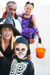 Image showing Portrait, halloween and a family in costume for the tradition of trick or treat or holiday celebration. Mother, father and kids at a door in fantasy clothes for dress up on allhallows eve together