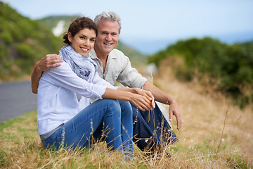 Image showing Couple, face and happy outdoor with relax, communication and peace for bonding, relationship or roadtrip. Mature, man and woman with smile, sitting and break in nature with travel, vacation and trust