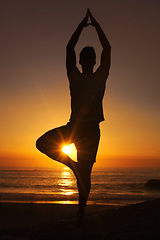 Image showing Silhouette, man and praying with hands for yoga, health and wellness on beach with sunset and zen. Person, shadow and pilates or namaste for balance, mindfulness and healthy body by ocean or sea