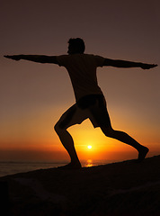 Image showing Silhouette, man or stretching with hands for yoga, health and wellness on beach with sunset and zen. Person, shadow and pilates or arm workout for balance, mindfulness or healthy body by ocean or sea